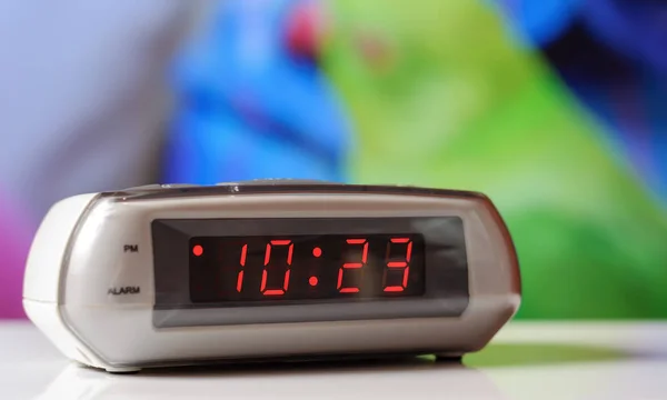 White electronic clock with a red dial. White clock with an alarm clock — Stock Photo, Image