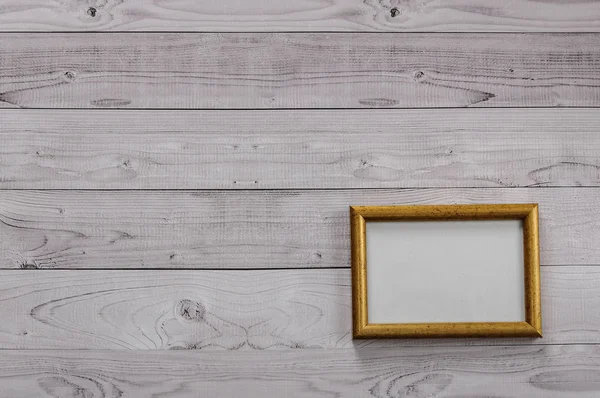 Frame for photography on a light, vintage wooden background