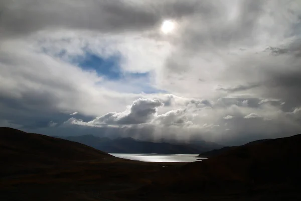 Brown mountains, blue lakes, changing clouds, a beautiful plateau scenery