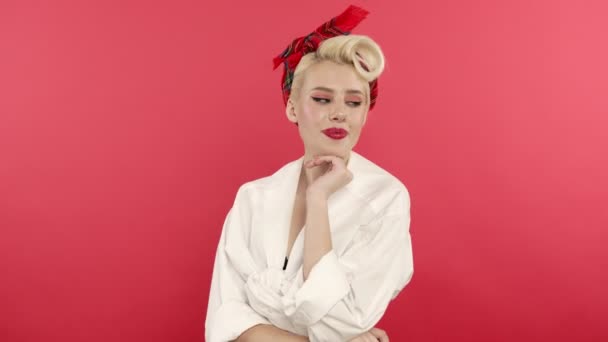 Flirty pin up woman in white shirt smiling on pink background — Stock Video