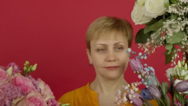 Mujer madura sorprendida mirando flores y tomando ramo de tulipanes — Vídeos de Stock