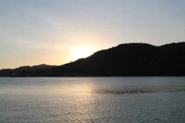 A sunset over a body of water — Stock Photo, Image