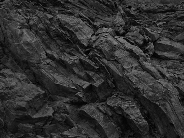     Black rock background. Dark gray stone texture. Black grunge background. Mountain close-up. Distressed backdrop.                           