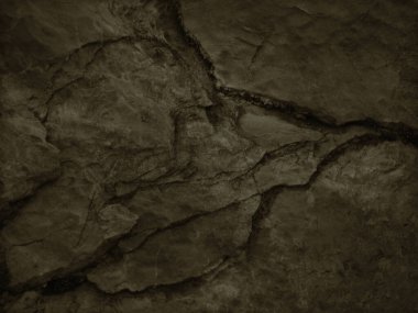        Brown grunge background. Toned rock texture with cracks and layers. Dark brown background of rough dirty stone surface.                        