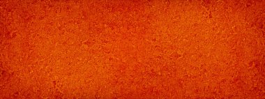 Kırmızı soyut arka plan. Turuncu grunge arkaplan. Renkli fiberboard dokusu. Parlak, pürüzlü, sert bir yüzey. Yakın plan. Tasarımınız için kopyalama alanı olan kırmızı grunge pankartı.