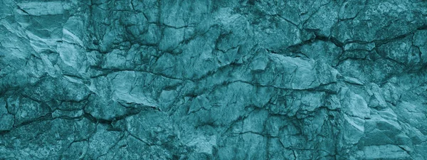 Blue green stone background. Underwater rocky texture. Close-up. Toned mountain texture. Color Trend 2020.