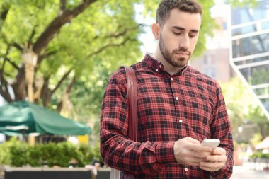 Telefonunu yazarak adam.