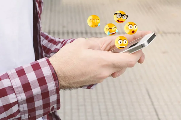 Hombre usando el teléfono inteligente enviar emojis . — Foto de Stock
