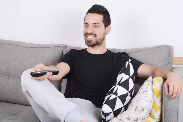 Mann schaut Fernsehen auf Couch. — Stockfoto