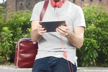 Genç adam tablet ile kulaklık kullanma.