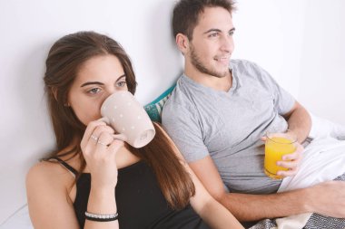 Çift yatakta kahvaltı yapıyor..