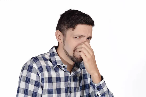 Man holding nose against bad smell. — Stock Photo, Image