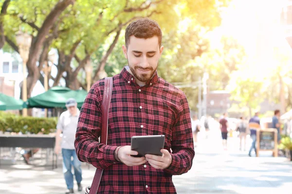 Young latin man using a tablet — Stock Photo, Image