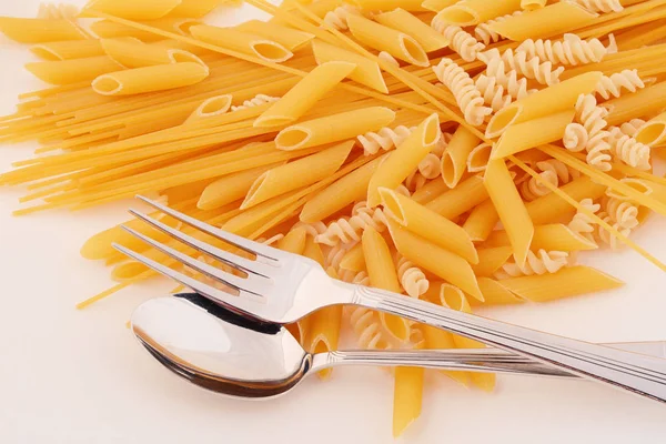Various types of pasta on a white background. — Stock Photo, Image