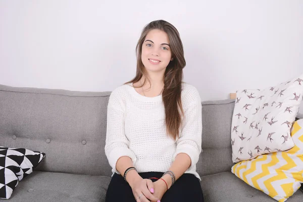 Woman relaxed on couch.