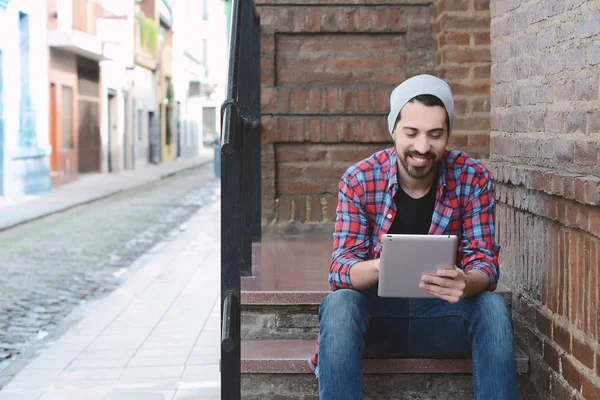 Young latin man using a tablet — Stock Photo, Image