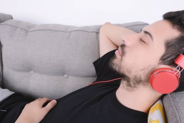 adam kanepede müzik dinleme.