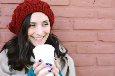 Sıcak kahve tutan genç kadın portresi