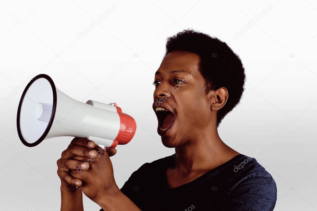 afro american man screaming on a megaphone.