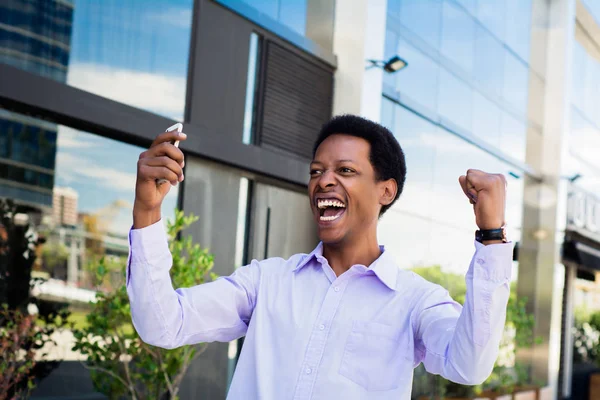 Businessman excited  looking at cell phone.