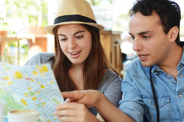 Молодая пара туристов смотрит на карту — стоковое фото