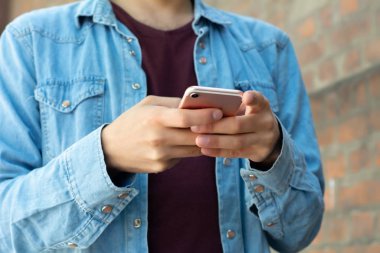 Genç adam telefonunu yazarak.