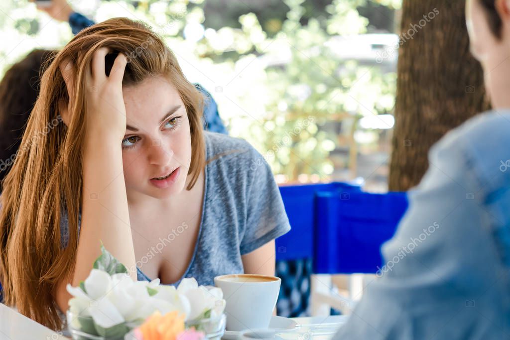 Young woman bored in a date.