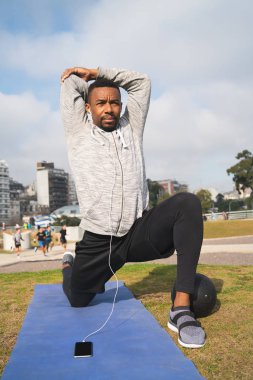 Atletik adam parkta egzersiz yapıyor..