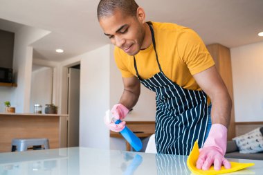 Genç Latin adam evi temizliyor..