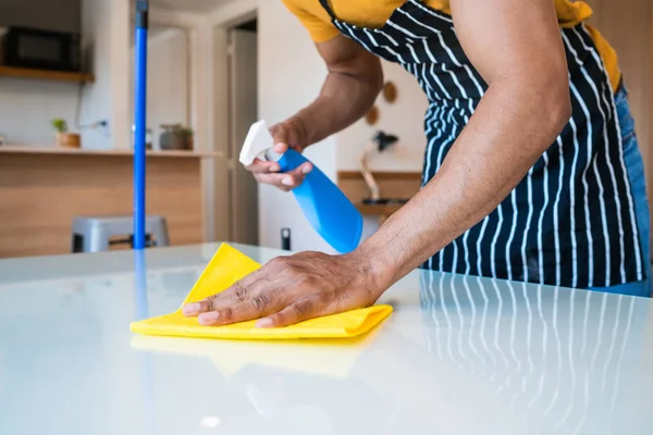 Man cleaning stains off the table. — Stock Photo, Image