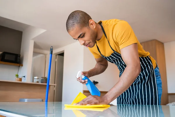 Fiatal latin férfi takarítás otthon. — Stock Fotó