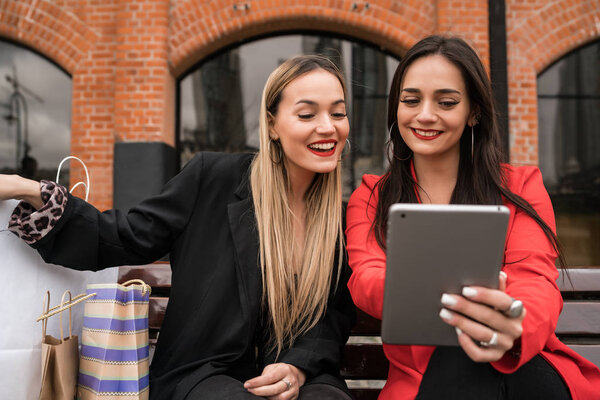Two young friends using digital tablet.