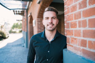 Portrait of young man with urban background.