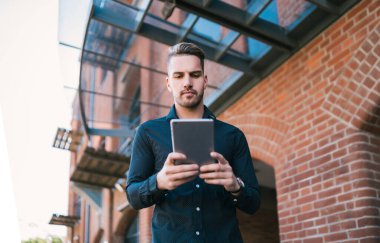 Adam dışarıda dijital tabletini kullanıyor..