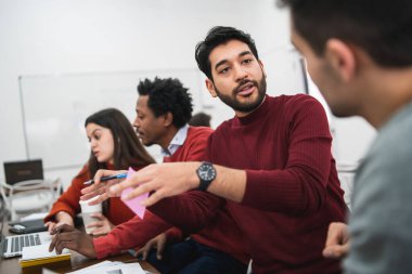 İki yaratıcı tasarımcı bir projede birlikte çalışıyor ve işyerleri hakkında yeni fikirleri paylaşıyorlar. İş ve takım çalışması kavramı.