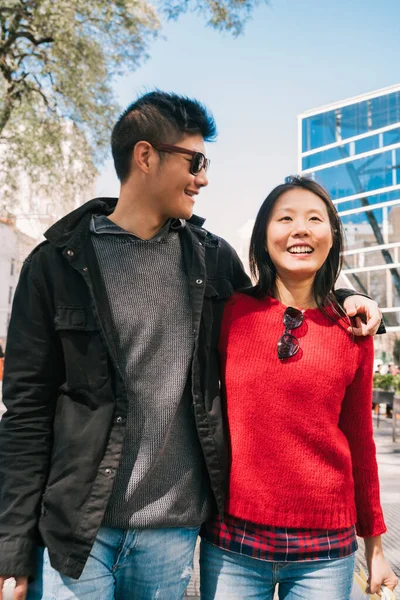 Portrait of young Asian couple in love walking in the city after shopping. Shop concept.