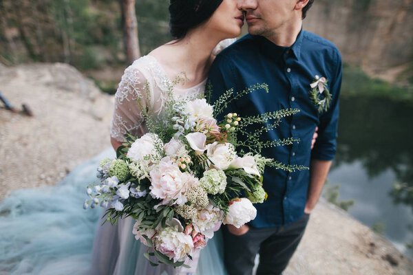couple on rocky lake shore
