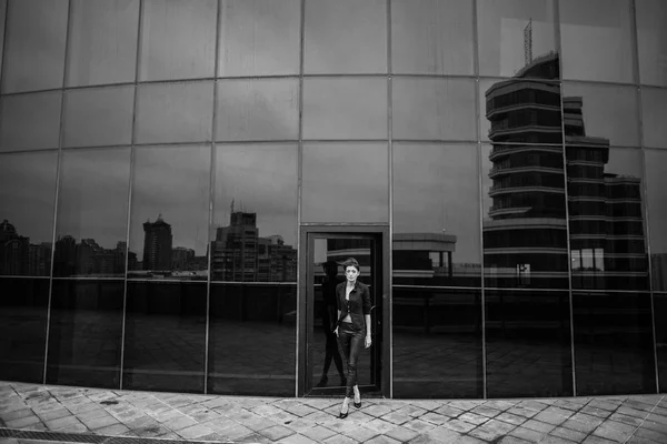 woman near glass facade