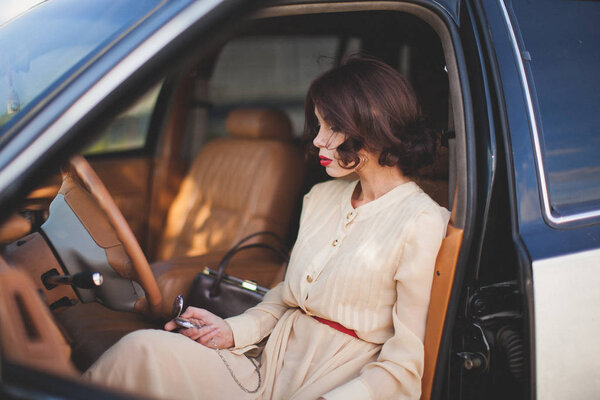 woman sitting in vintage car 