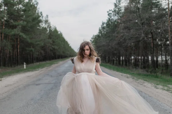 Pregnant woman on road in forest — Stock Photo, Image