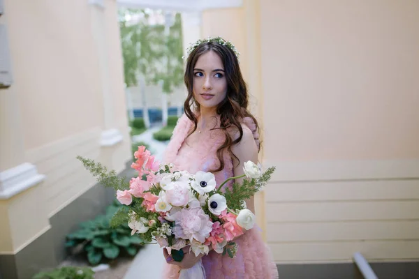 Girl with bouquet near house — Stock Photo, Image