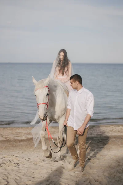 Groom with bride on horse — Stock Photo, Image