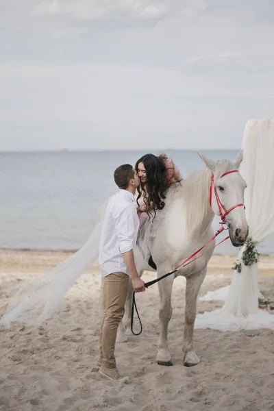 Groom with bride on horse — Stock Photo, Image