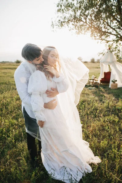 Jovem casal sob véu branco — Fotografia de Stock