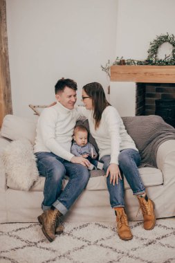 bebek çocuk ile kanepede oturan genç çift portresi