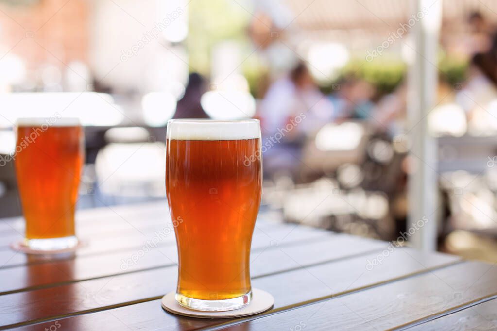 Glass of craft IPA beer on a table during beer festival in Belarus. India pale ale hoppy beer