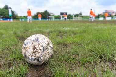 Nakhon Ratchasima, Thailand - October 1 : Muddy soccer ball on a football field in Municipal Stadium Nakhon Ratchasima on October 1, 2016, in Thailand. clipart