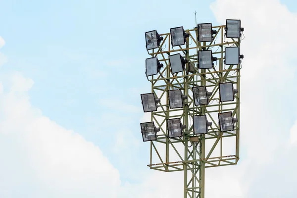 Sport stadium floodlights on a cloudy background.