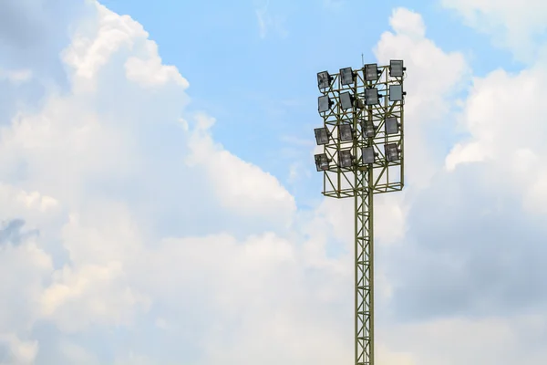 Sport stadium floodlights on a cloudy background.