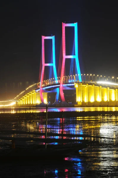 The Suramadu Bridge at Twilight with colorful lighting in Surabaya,Indonesia.Is the longest Bridge in Indonesia.